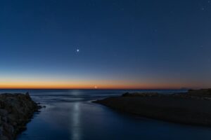 twilight view of crescent moon over valencia coastline