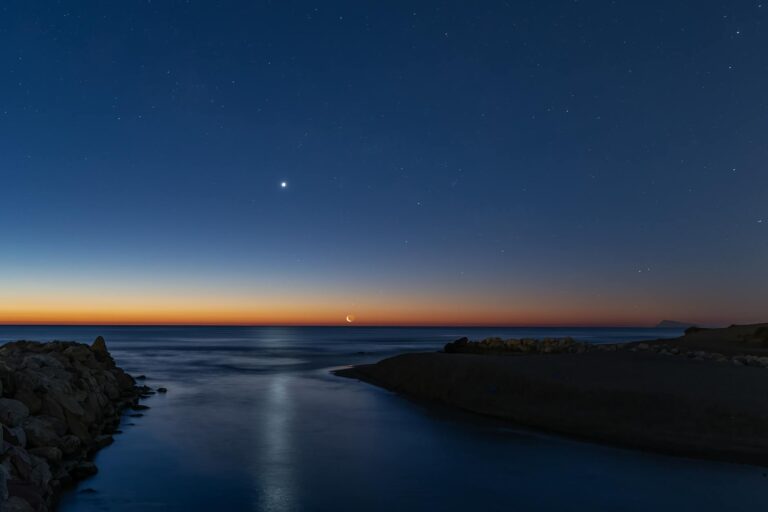 twilight view of crescent moon over valencia coastline